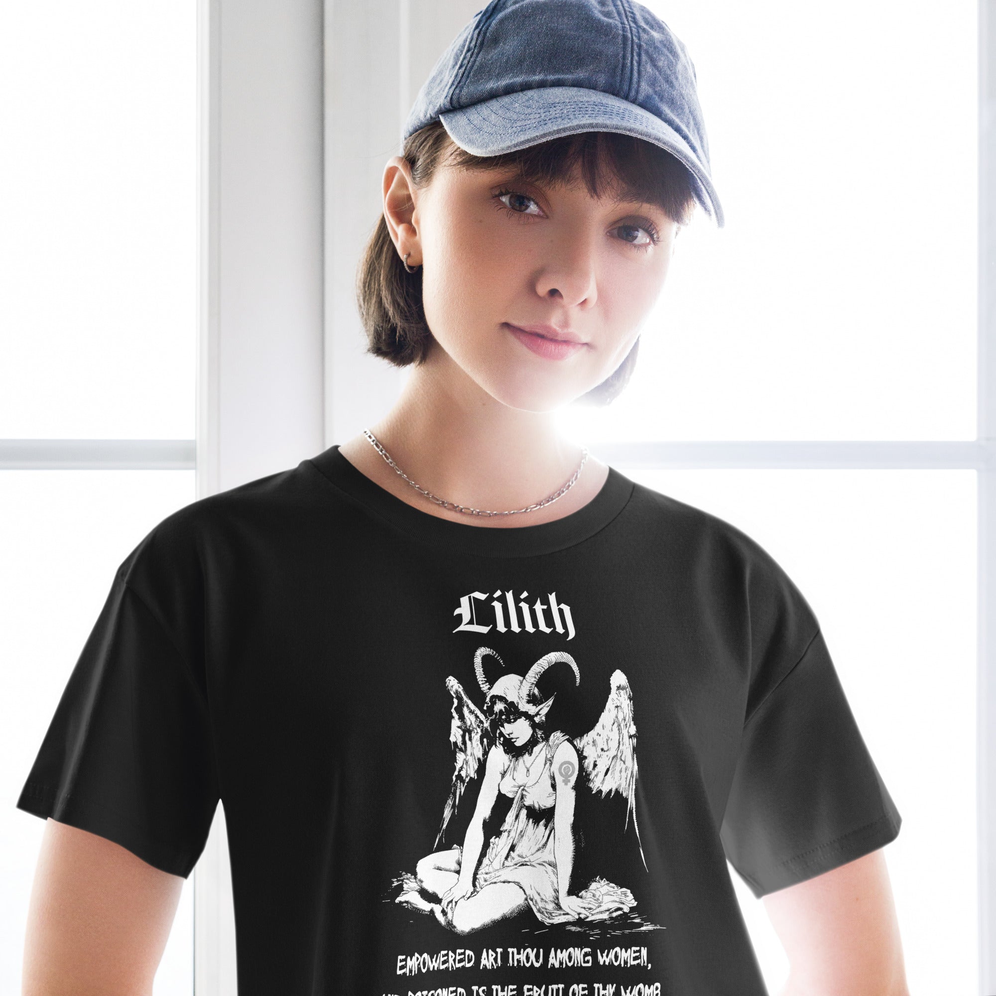 Black cropped cotton t-shirt featuring a black-and-white Lilith illustration with horns, wings, and gothic lettering.