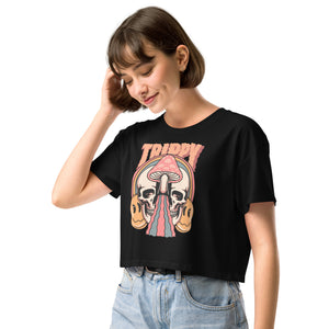 Cropped tee featuring a split skull and mushroom design with melting psychedelic color and smiley faces. Soft combed cotton, eco-friendly inks, playful surreal vibe.