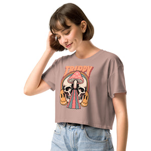 Cropped tee featuring a split skull and mushroom design with melting psychedelic color and smiley faces. Soft combed cotton, eco-friendly inks, playful surreal vibe.