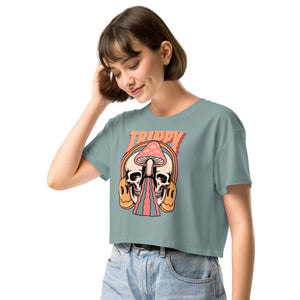 Cropped tee featuring a split skull and mushroom design with melting psychedelic color and smiley faces. Soft combed cotton, eco-friendly inks, playful surreal vibe.