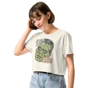 A side view of a distressed Frankenstein head with “Spook Show” on premium natural crop top.