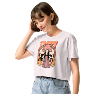 Cropped tee featuring a split skull and mushroom design with melting psychedelic color and smiley faces. Soft combed cotton, eco-friendly inks, playful surreal vibe.