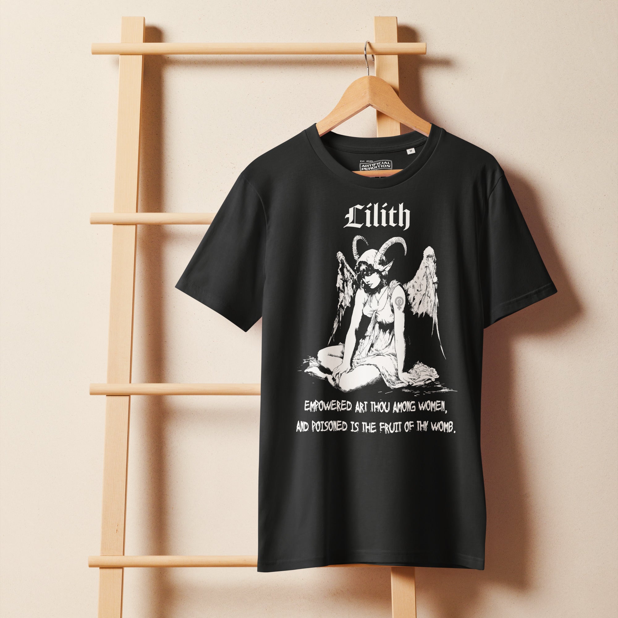 Organic mid-light cotton t-shirt featuring a black-and-white Lilith illustration with horns and wings and gothic lettering.