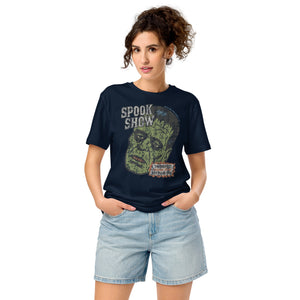 A woman standing wearing a distressed Frankenstein head with “Spook Show” on a premium mid-light organic Fench Navy tee.