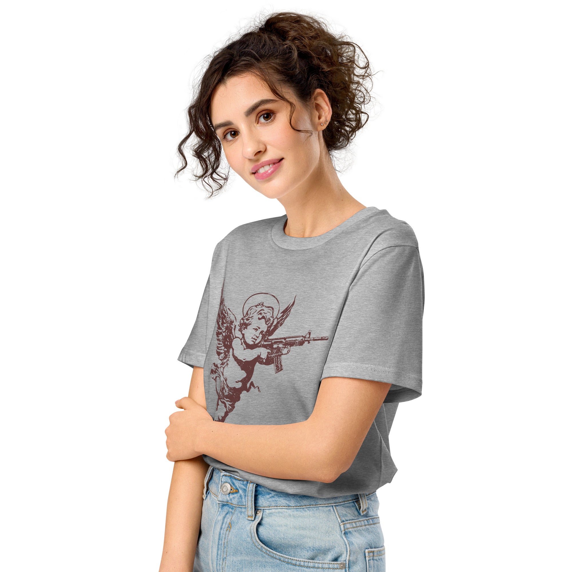A woman wearing an angelic cherub with a rifle on a distressed premium organic eco mid-light heather grey t-shirt.