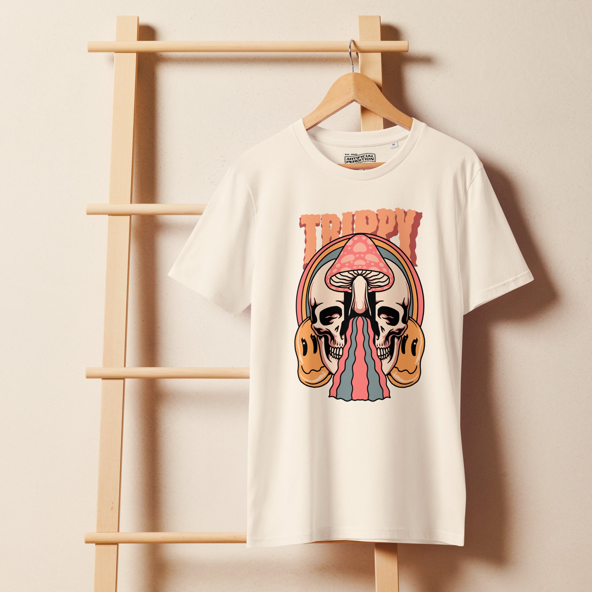 Mid-light organic cotton t-shirt showing a split skull divided by a pink mushroom, with flowing psychedelic shapes and small smiley faces.