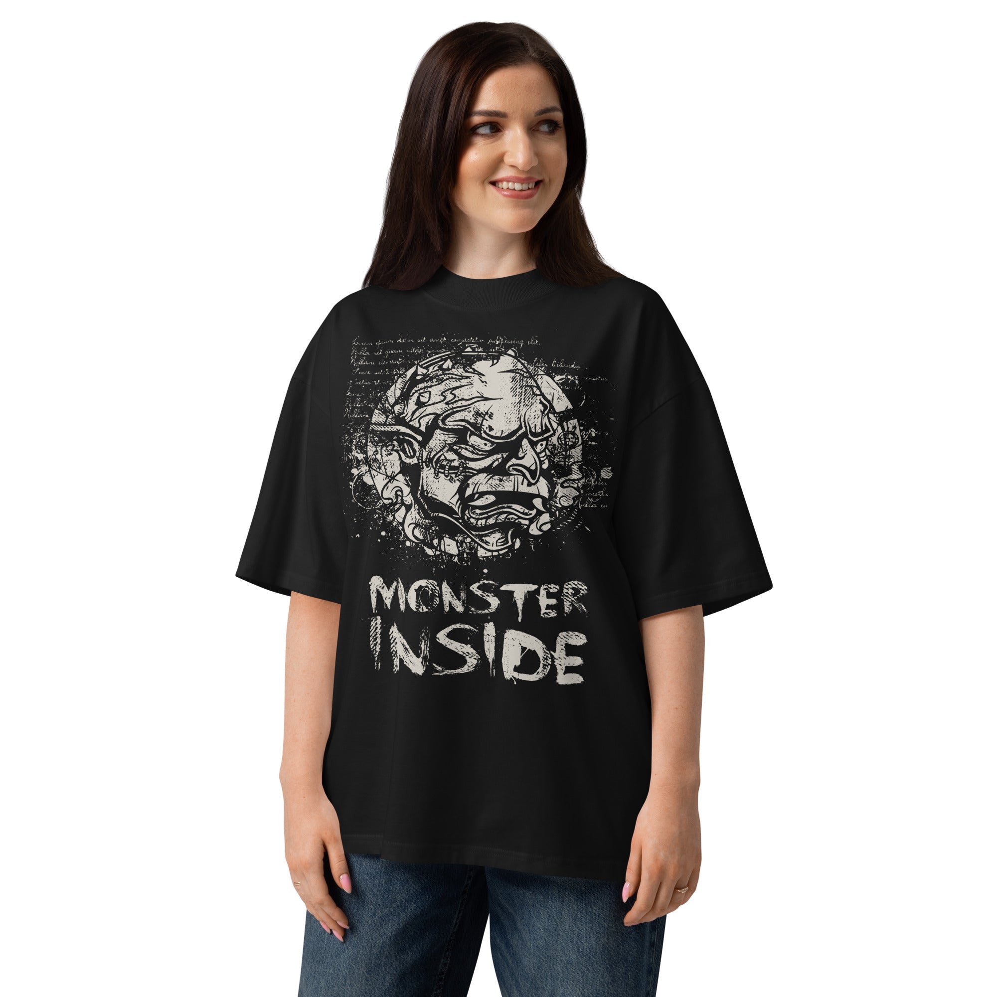 Black oversized organic cotton t-shirt featuring horned monster within ritual circle and fractured script background.