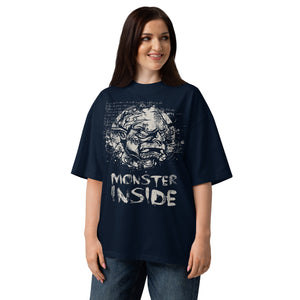 Black oversized organic cotton t-shirt featuring horned monster within ritual circle and fractured script background.