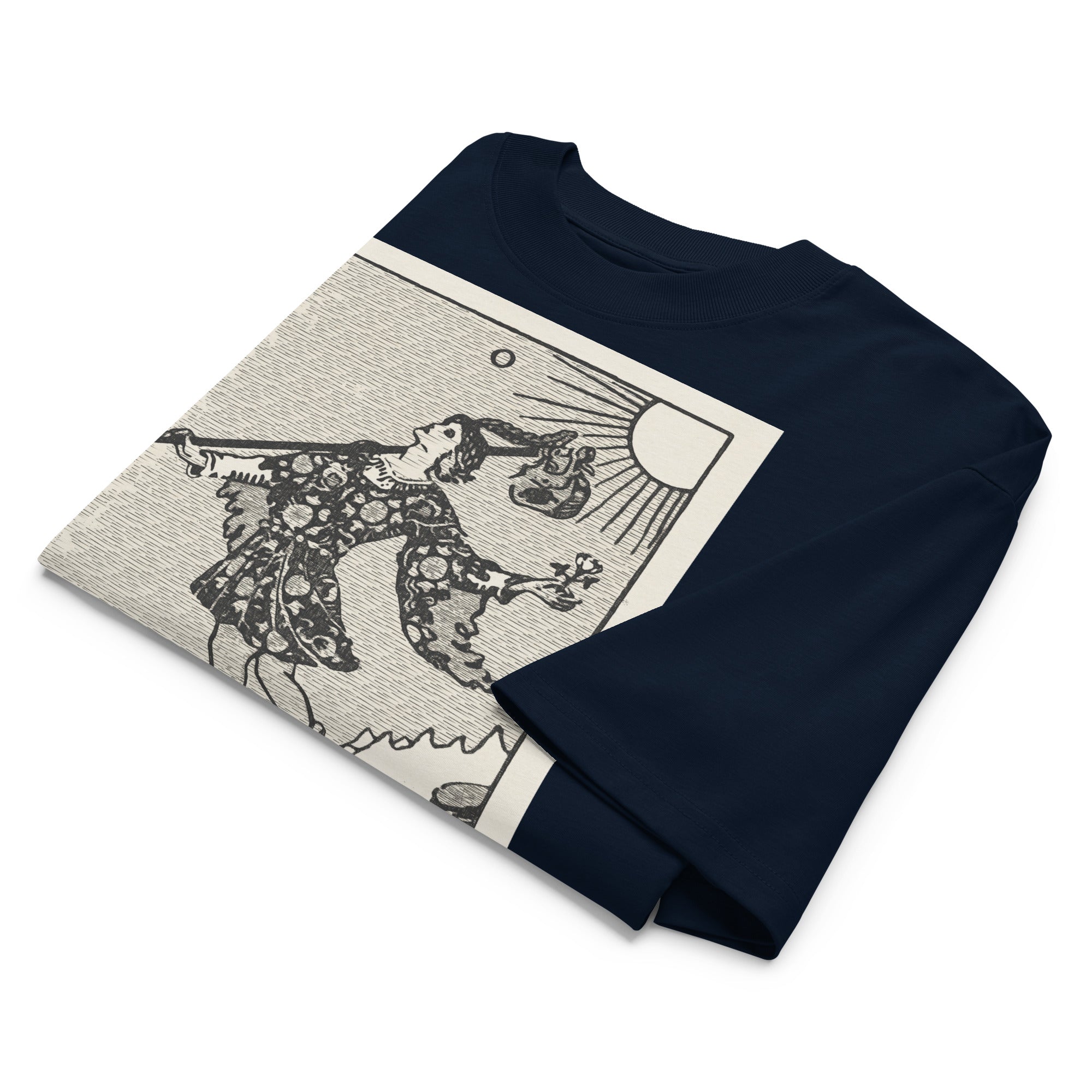 Oversized organic cotton t-shirt displaying The Fool tarot card with cliff, dog, and rising sun in modern woodcut style.