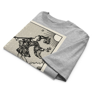 Oversized organic cotton t-shirt displaying The Fool tarot card with cliff, dog, and rising sun in modern woodcut style.