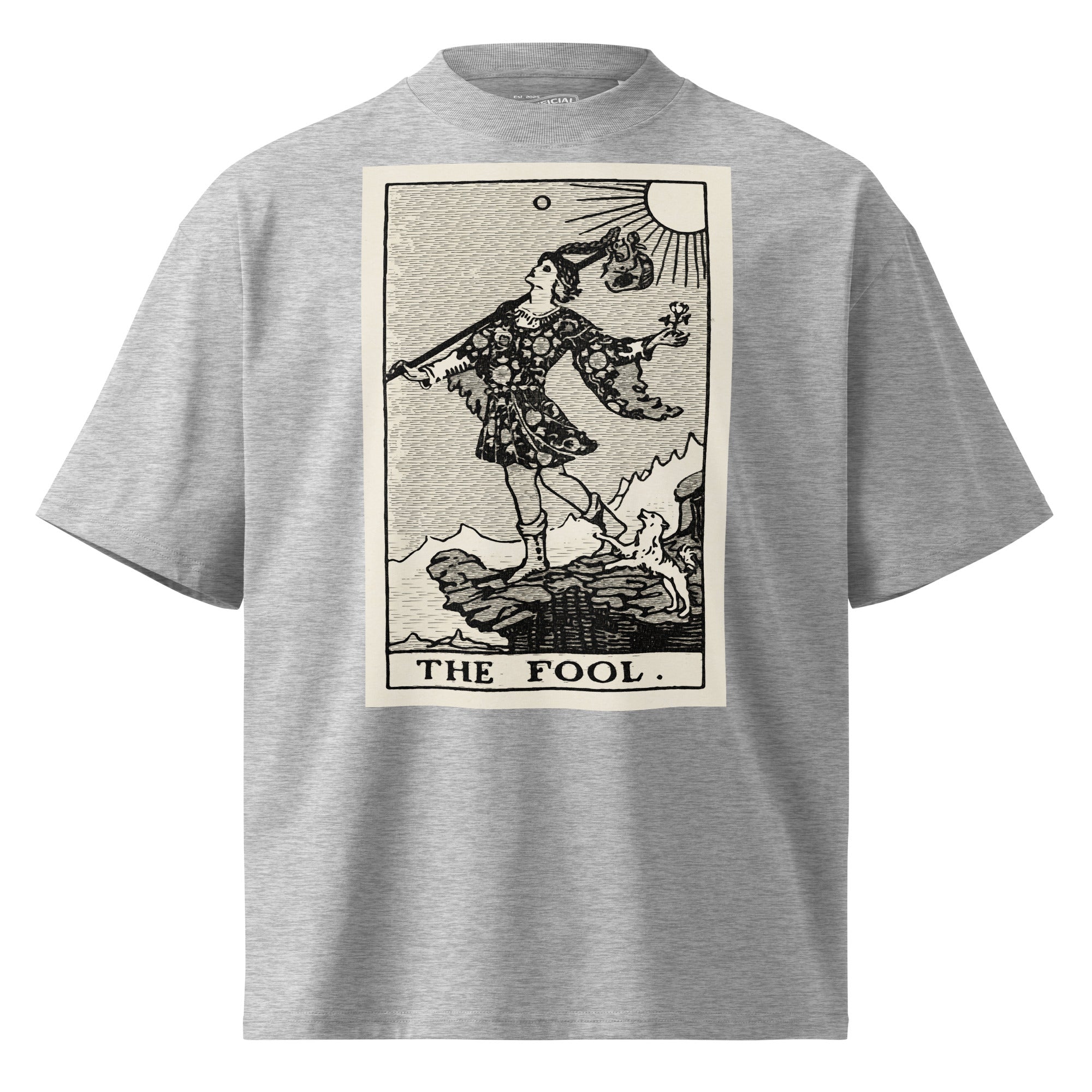 Oversized organic cotton t-shirt displaying The Fool tarot card with cliff, dog, and rising sun in modern woodcut style.