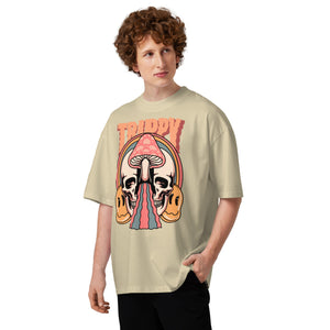 Oversized organic cotton t-shirt showing a split skull pierced by a pink mushroom, with melting psychedelic shapes and small smiley faces.