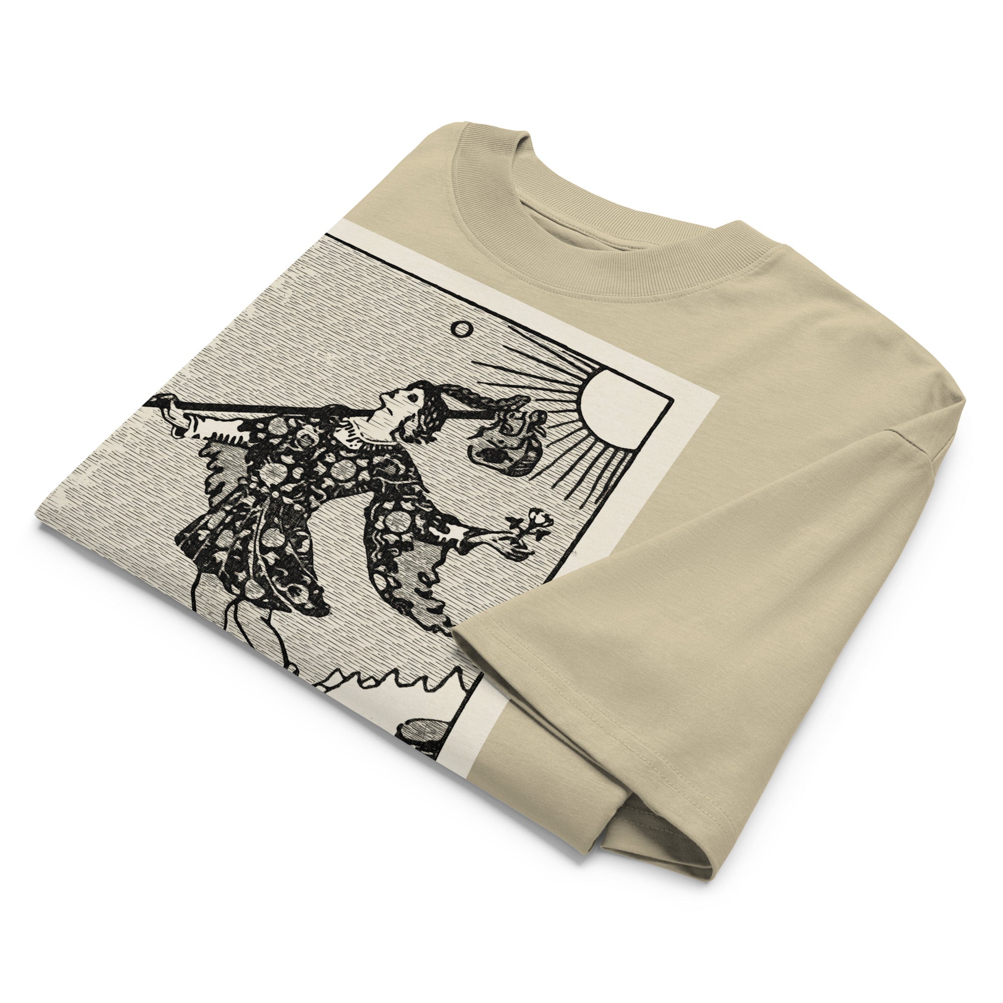 Oversized organic cotton t-shirt displaying The Fool tarot card with cliff, dog, and rising sun in modern woodcut style.