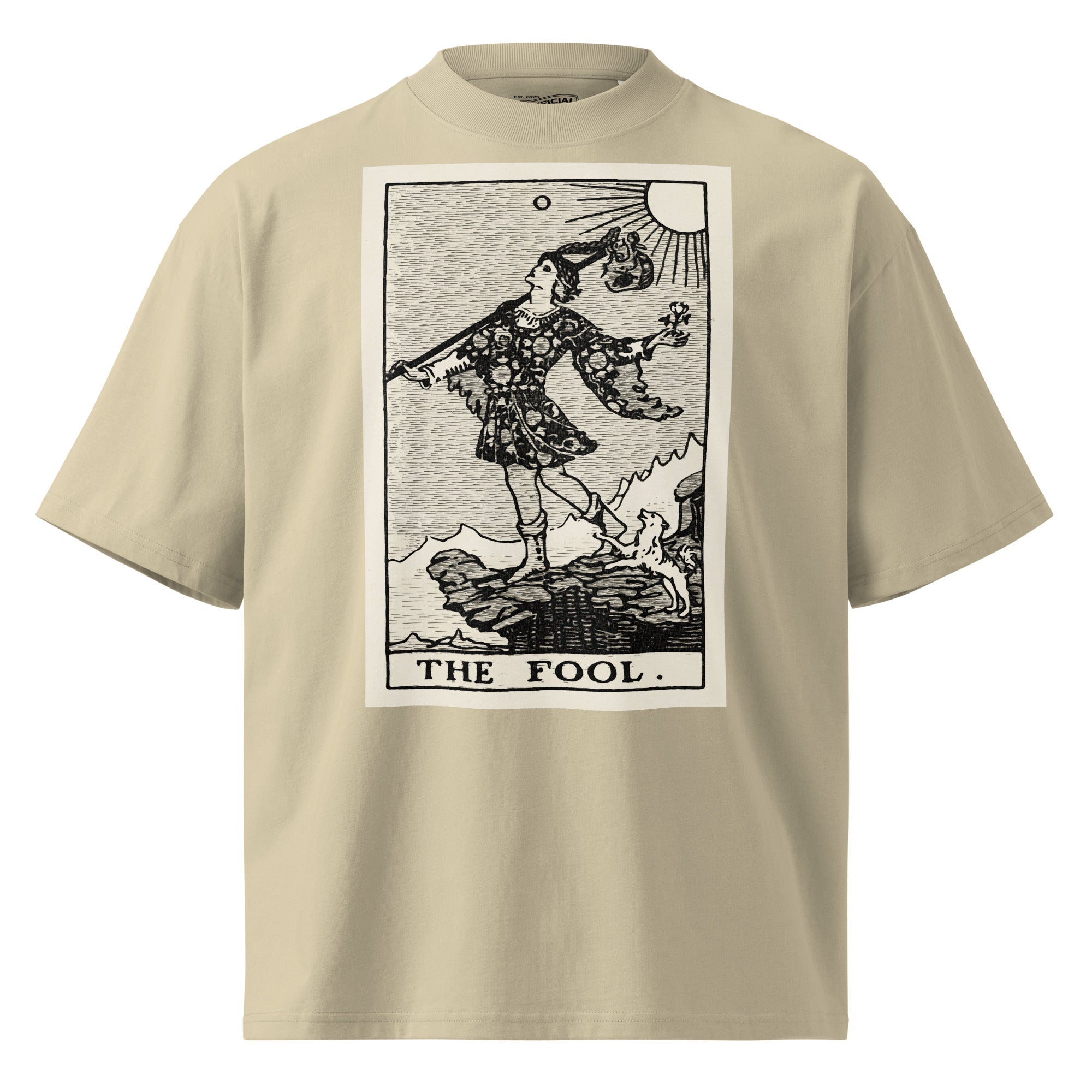 Oversized organic cotton t-shirt displaying The Fool tarot card with cliff, dog, and rising sun in modern woodcut style.