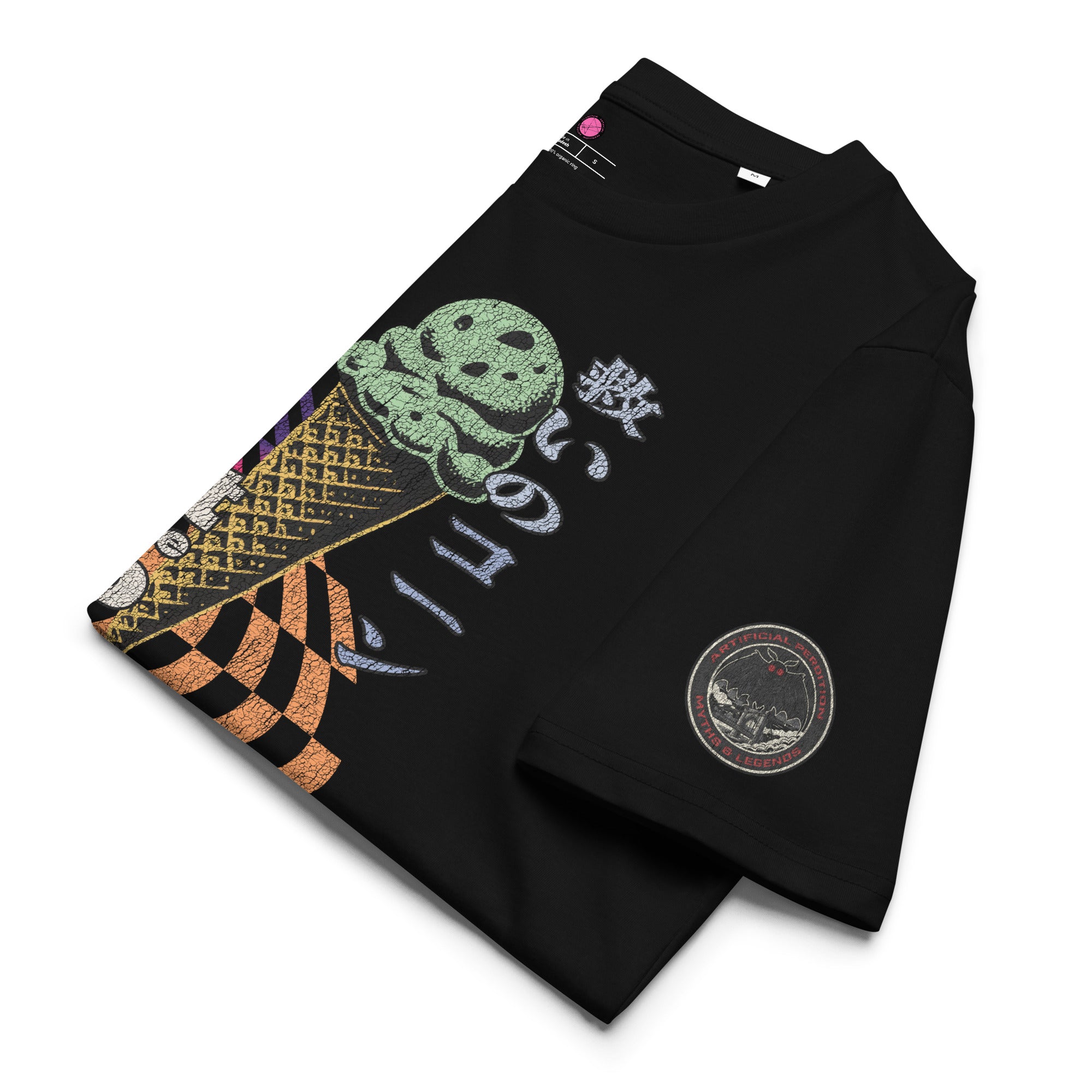 The lfolded view of a black heavyweight tee featuring half of an ice cream cone and the Japanese kanji 救いのコーン (Sukui no kōn) — “Cone of Salvation." There is a circular badge of mothman over a bridge with the words "artificial perdition | myths & legends."