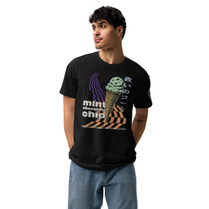 A man wearing a black core tee featuring the word "mint chocolate chip," an ice cream cone, and the Japanese kanji “救いのコーン," which translates to "Cone of Salvation."