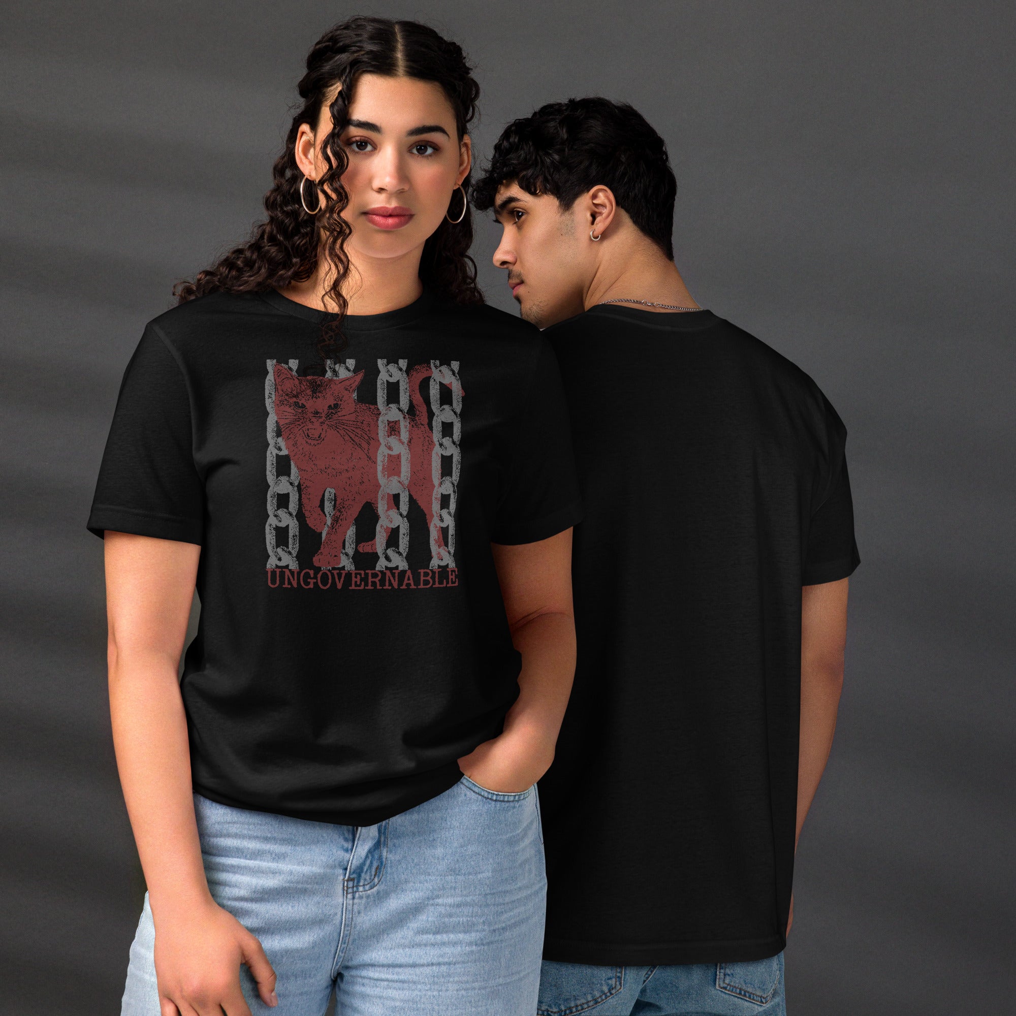 Snarling cat breaking through chains with UNGOVERNABLE text, dithered halftone red on cream, Artificial Perdition apparel
