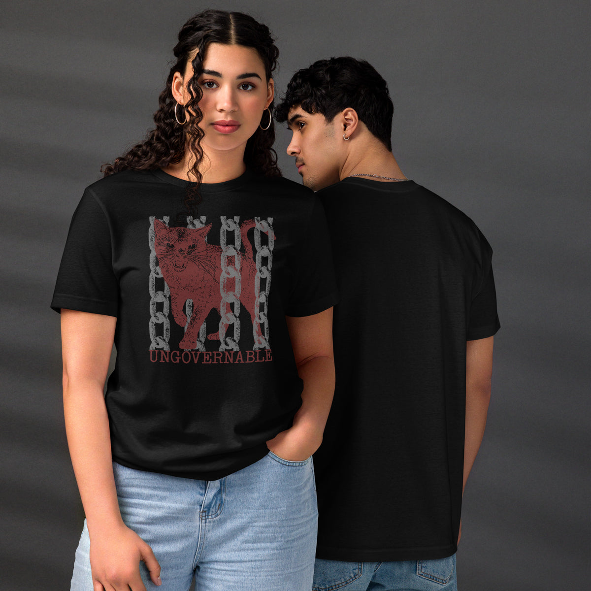 Product mockupSnarling cat breaking through chains with UNGOVERNABLE text, dithered halftone red on cream, Artificial Perdition apparel