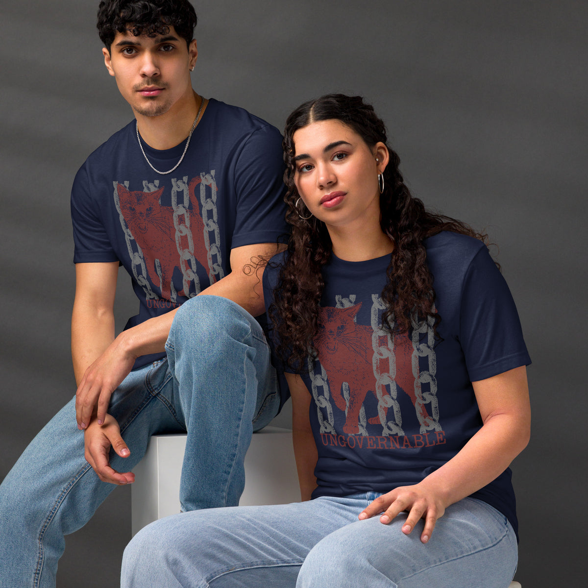 Product mockupSnarling cat breaking through chains with UNGOVERNABLE text, dithered halftone red on cream, Artificial Perdition apparel