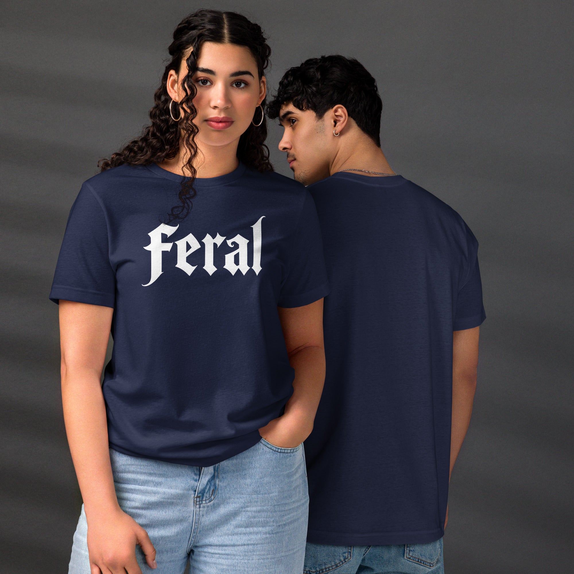 Feral in white blackletter font on dark heather grey t-shirt, bold single word graphic design, Artificial Perdition apparel
