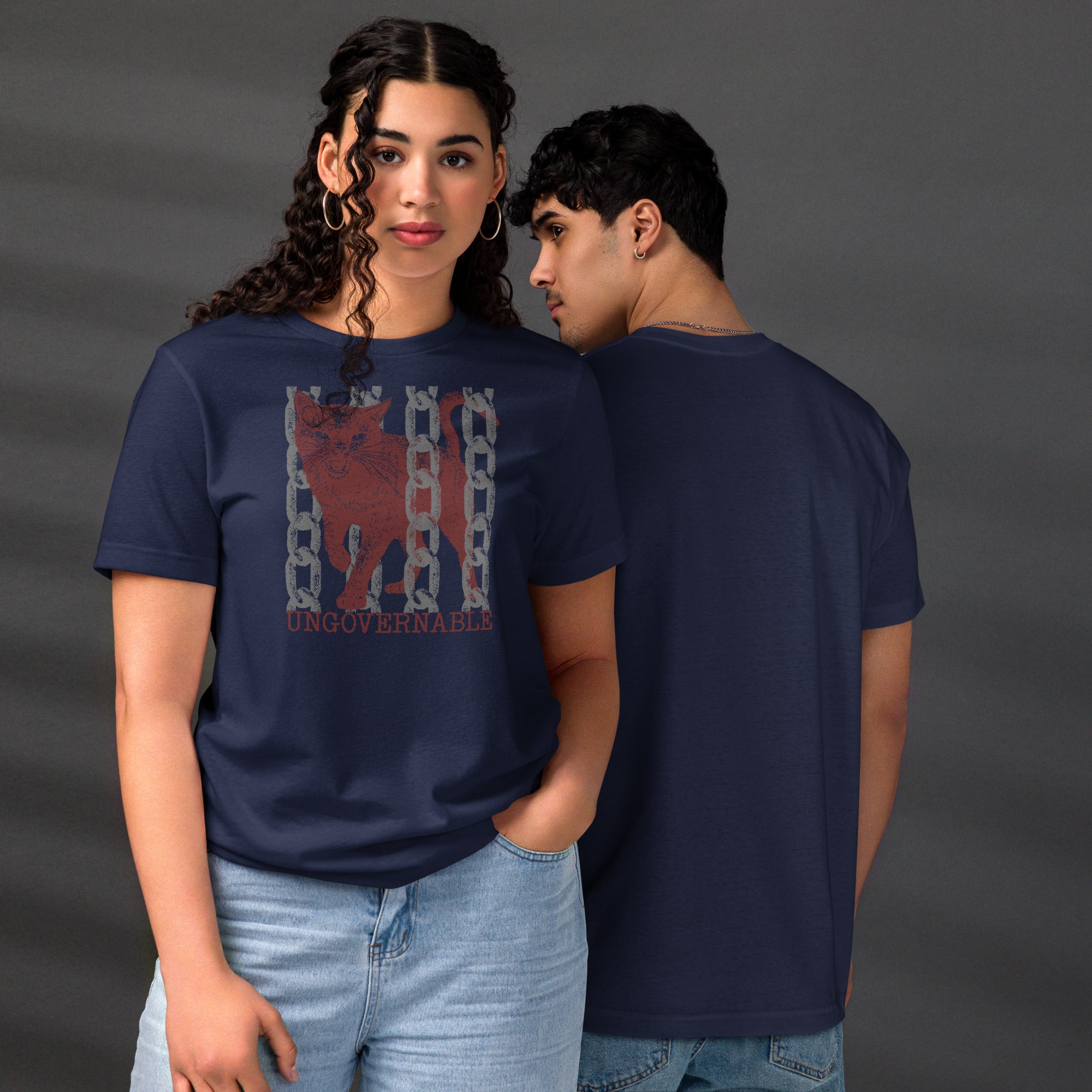 Snarling cat breaking through chains with UNGOVERNABLE text, dithered halftone red on cream, Artificial Perdition apparel