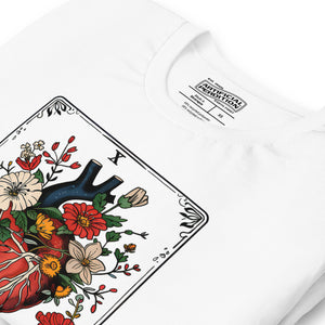 Tarot card illustration numbered X with an anatomical heart in bloom surrounded by wildflowers and vines, Amor Fati, Artificial Perdition apparel