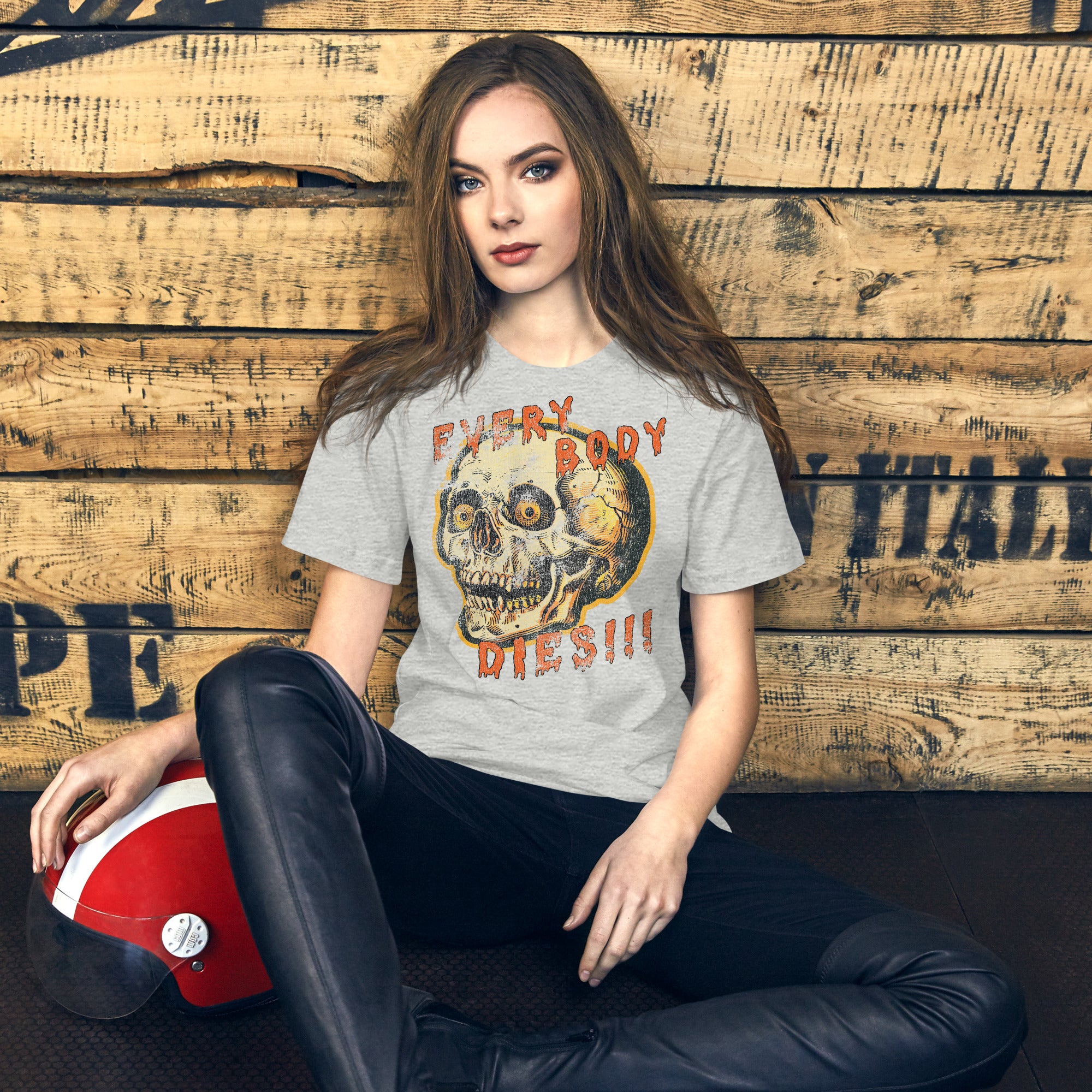 Product mockupDie-cut skull with amber eyes and dripping orange horror font reading EVERY BODY DIES, vintage pulp style, Artificial Perdition apparel