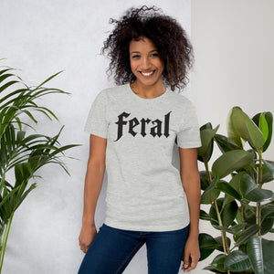 Feral in white blackletter font on dark heather grey t-shirt, bold single word graphic design, Artificial Perdition apparel