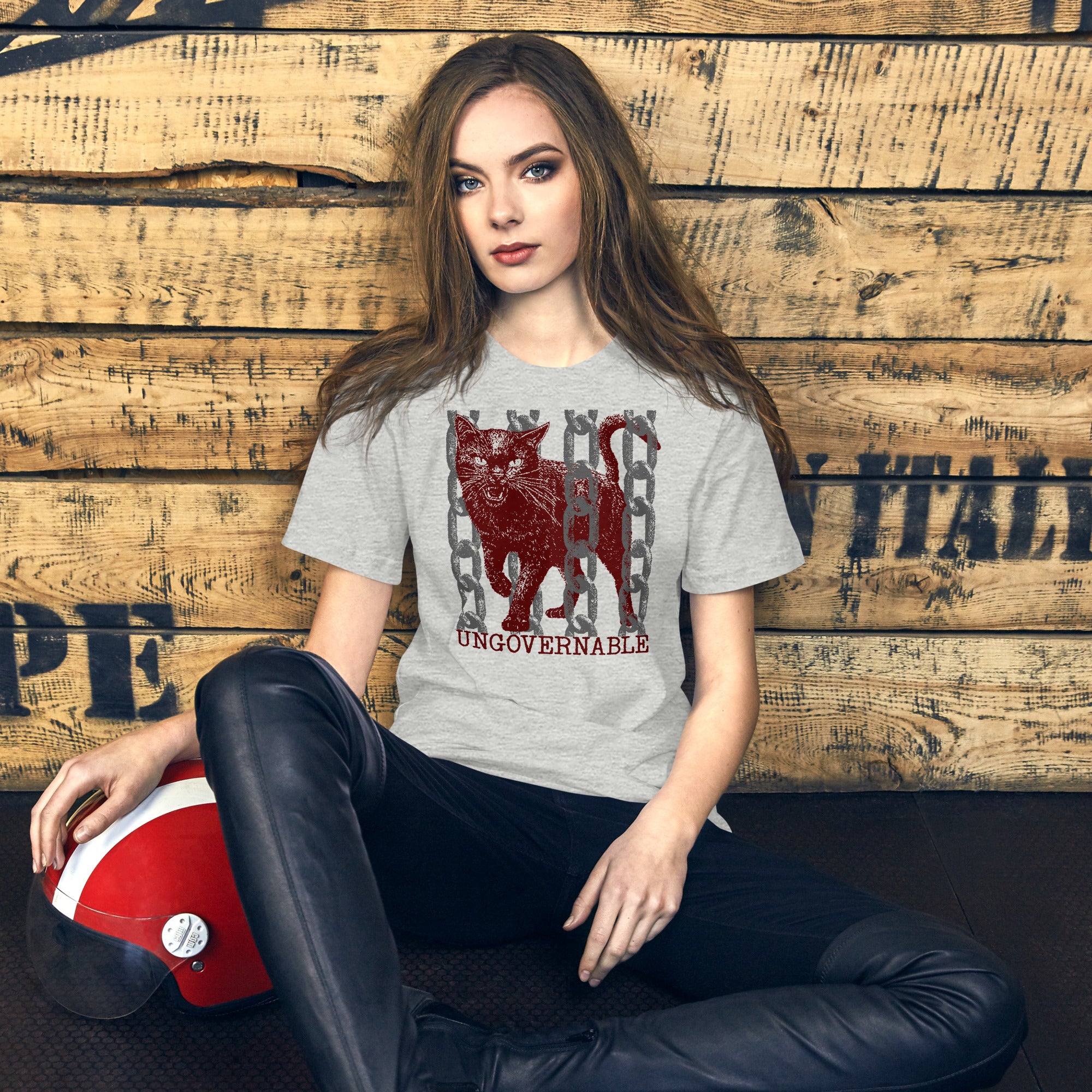 Product mockupSnarling cat breaking through chains with UNGOVERNABLE text, dithered halftone red on cream, Artificial Perdition apparel