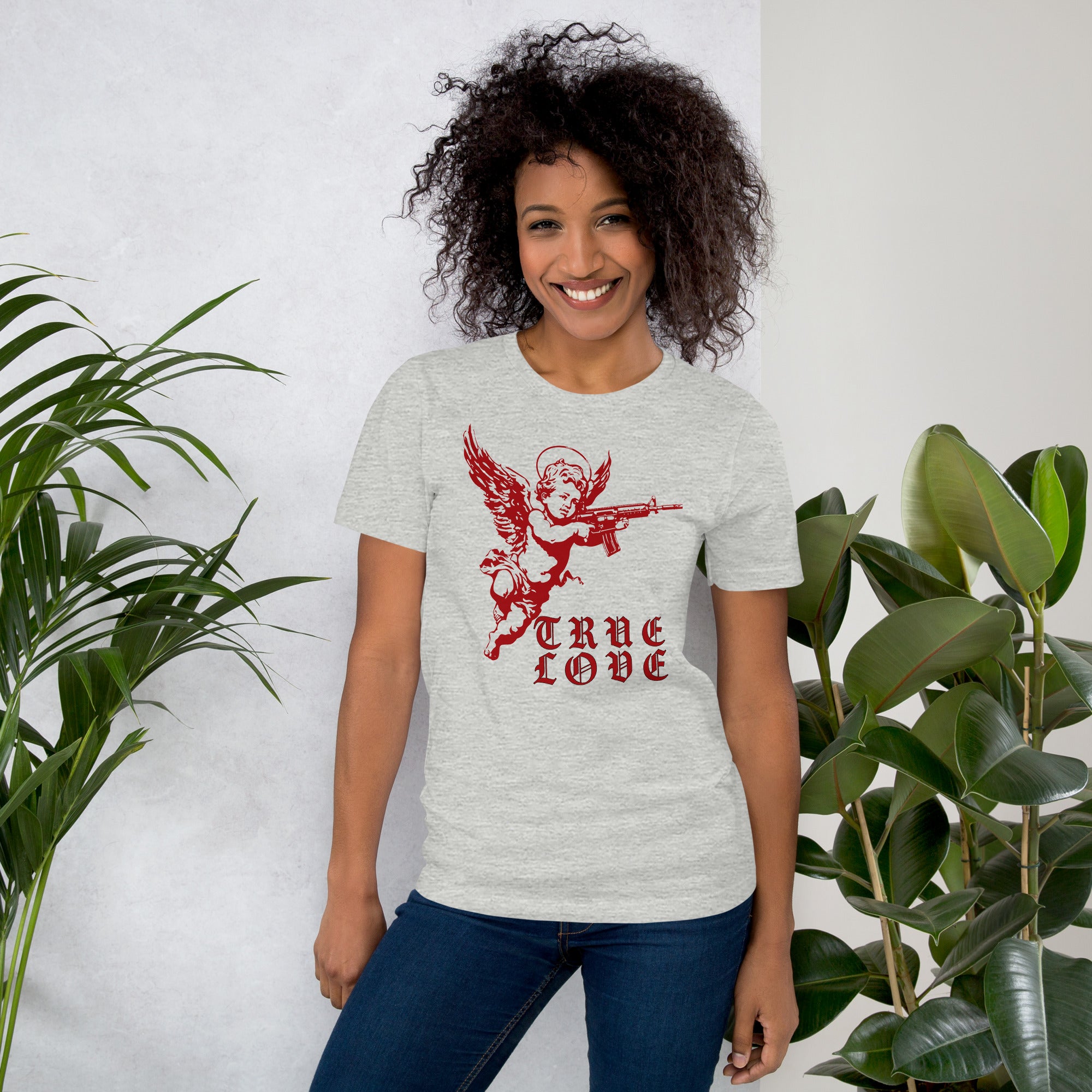 Red cherub angel with halo aiming rifle above blackletter True Love text, dark ironic tattoo flash style, Artificial Perdition apparel