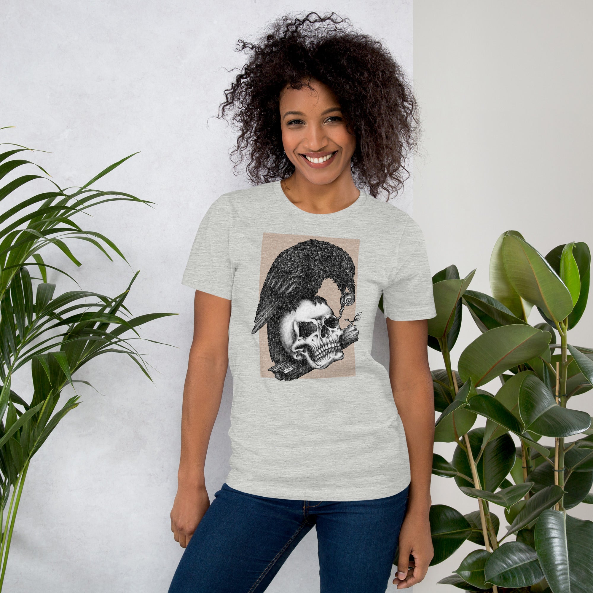 Graphite illustration of a black corvid perched on a human skull removing the eye, sprouting branch beside it, Last Look, Artificial Perdition apparel