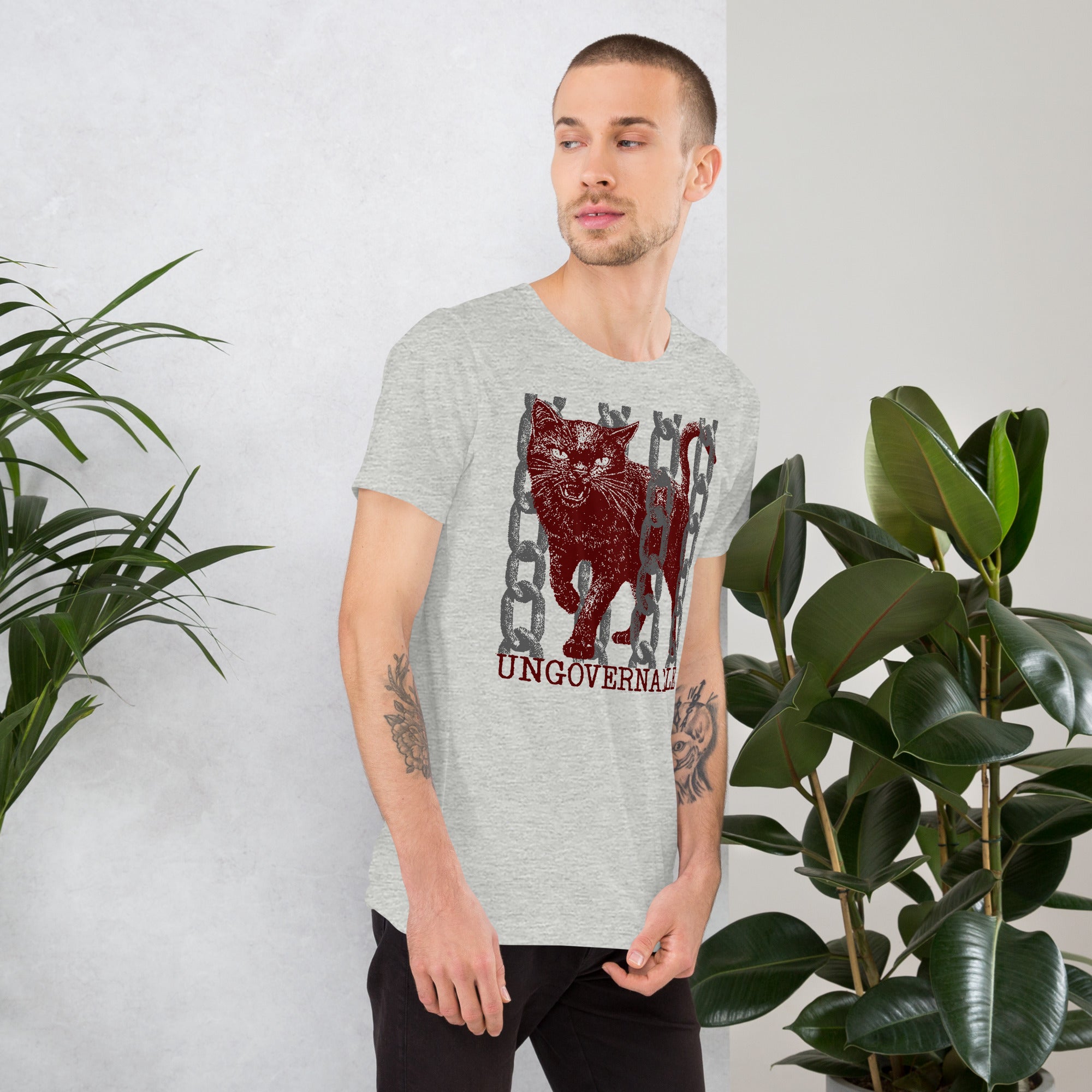 Snarling cat breaking through chains with UNGOVERNABLE text, dithered halftone red on cream, Artificial Perdition apparel