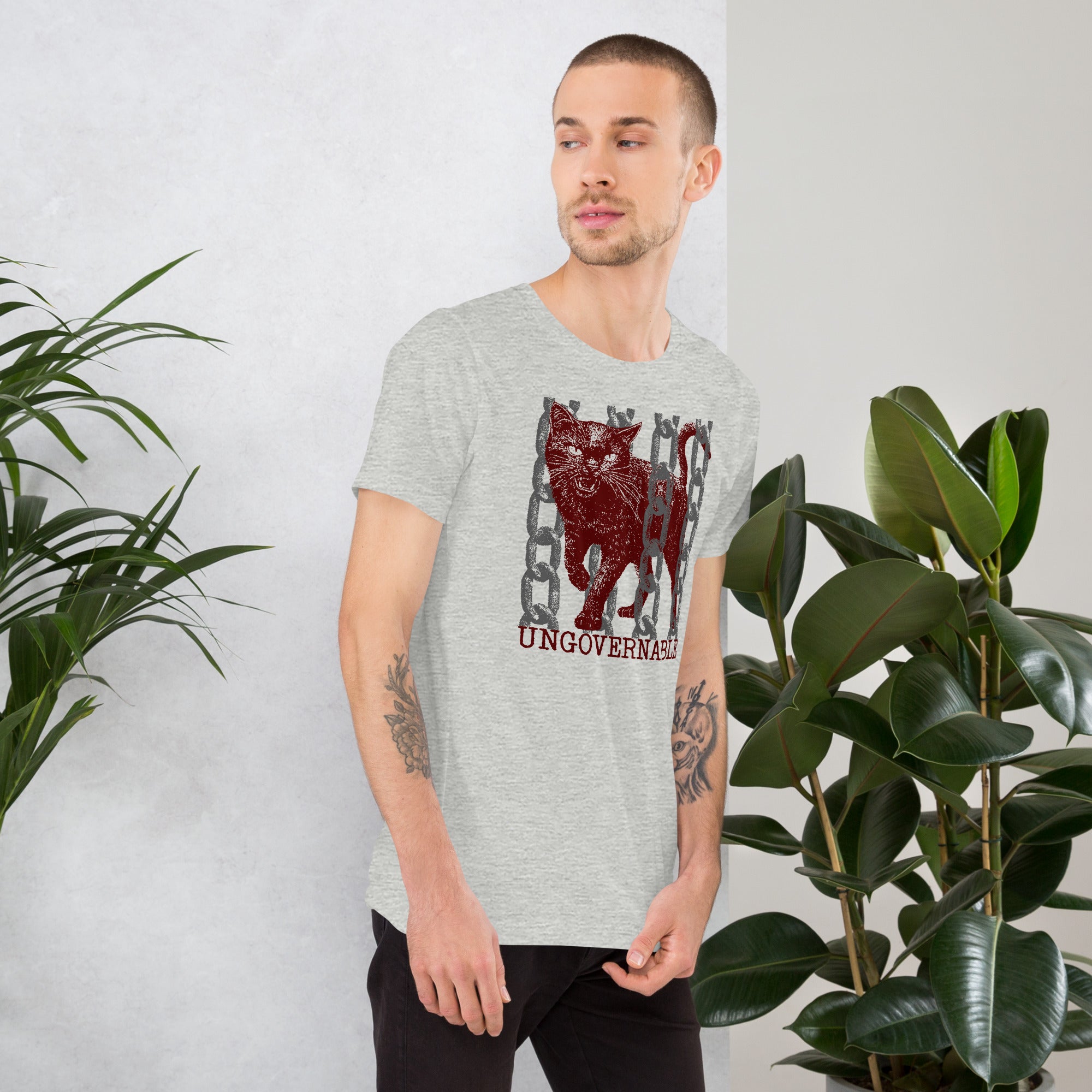 Product mockupSnarling cat breaking through chains with UNGOVERNABLE text, dithered halftone red on cream, Artificial Perdition apparel