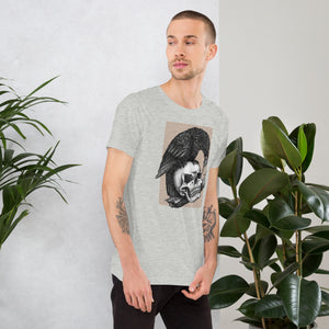 Graphite illustration of a black corvid perched on a human skull removing the eye, sprouting branch beside it, Last Look, Artificial Perdition apparel