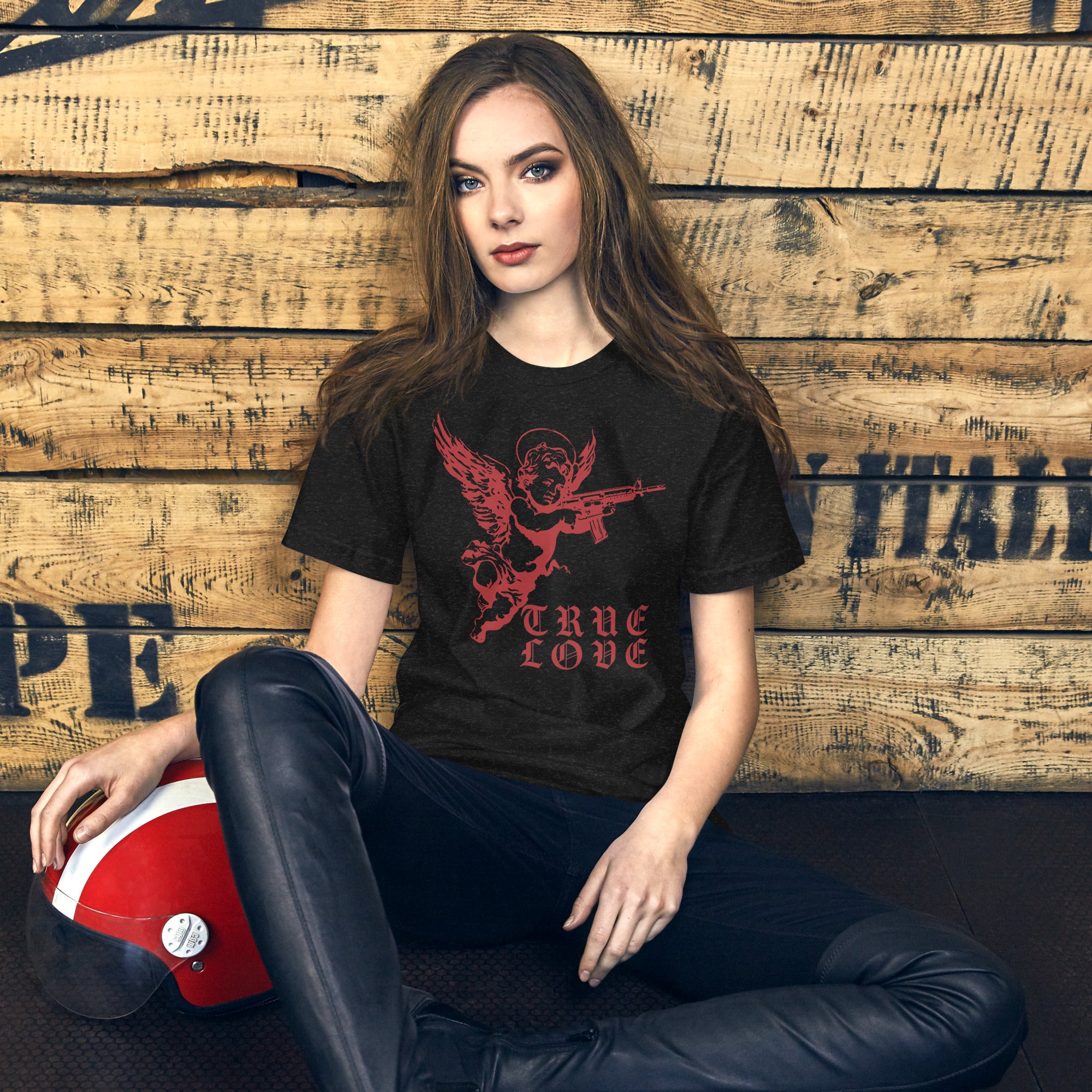 Red cherub angel with halo aiming rifle above blackletter True Love text, dark ironic tattoo flash style, Artificial Perdition apparel
