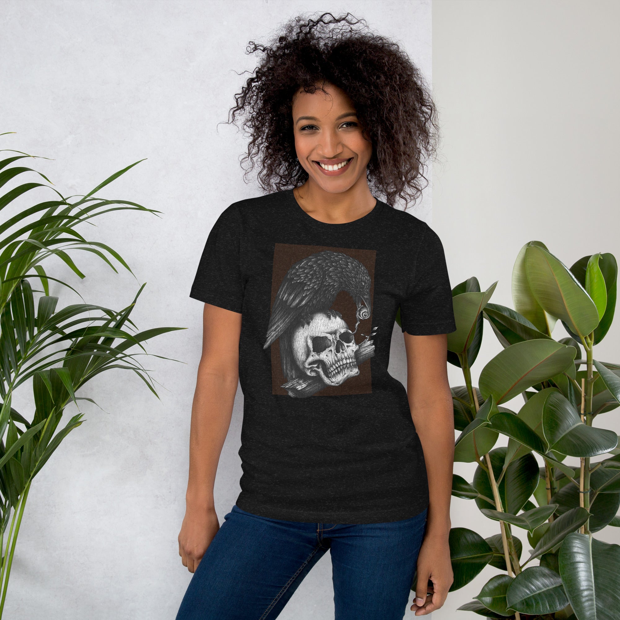 Graphite illustration of a black corvid perched on a human skull removing the eye, sprouting branch beside it, Last Look, Artificial Perdition apparel
