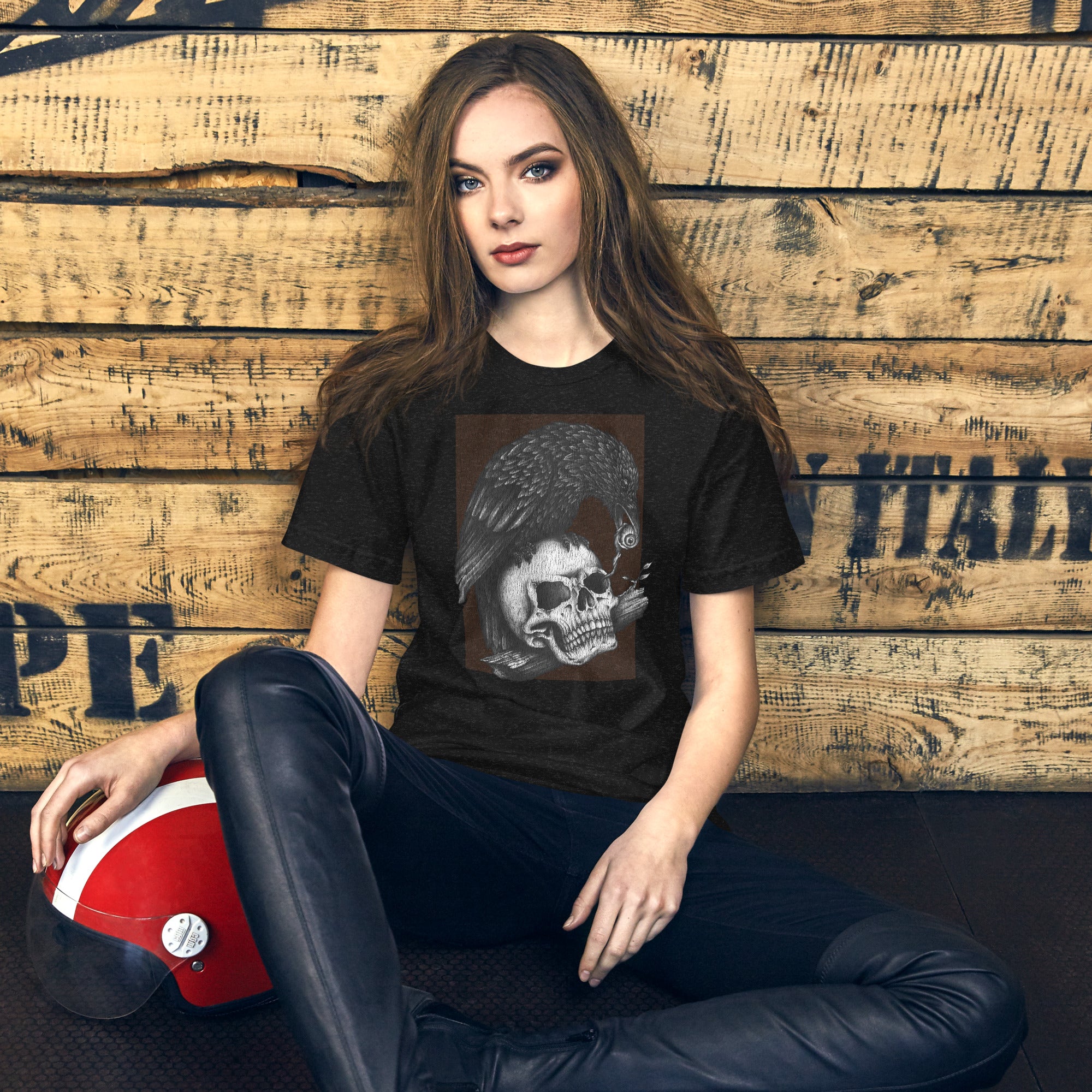 Graphite illustration of a black corvid perched on a human skull removing the eye, sprouting branch beside it, Last Look, Artificial Perdition apparel
