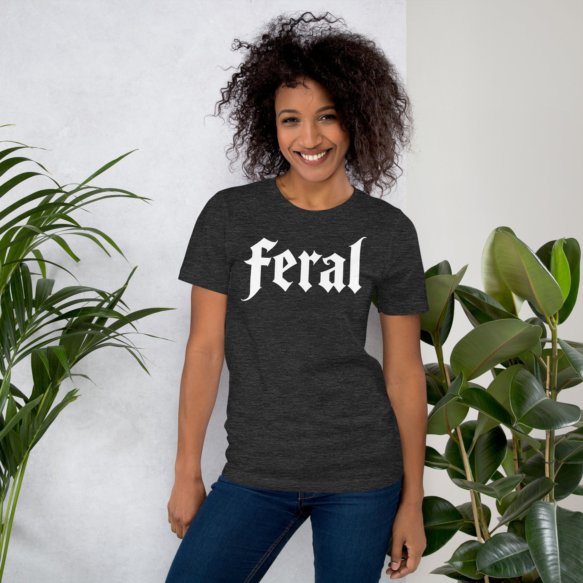 Feral in white blackletter font on dark heather grey t-shirt, bold single word graphic design, Artificial Perdition apparel