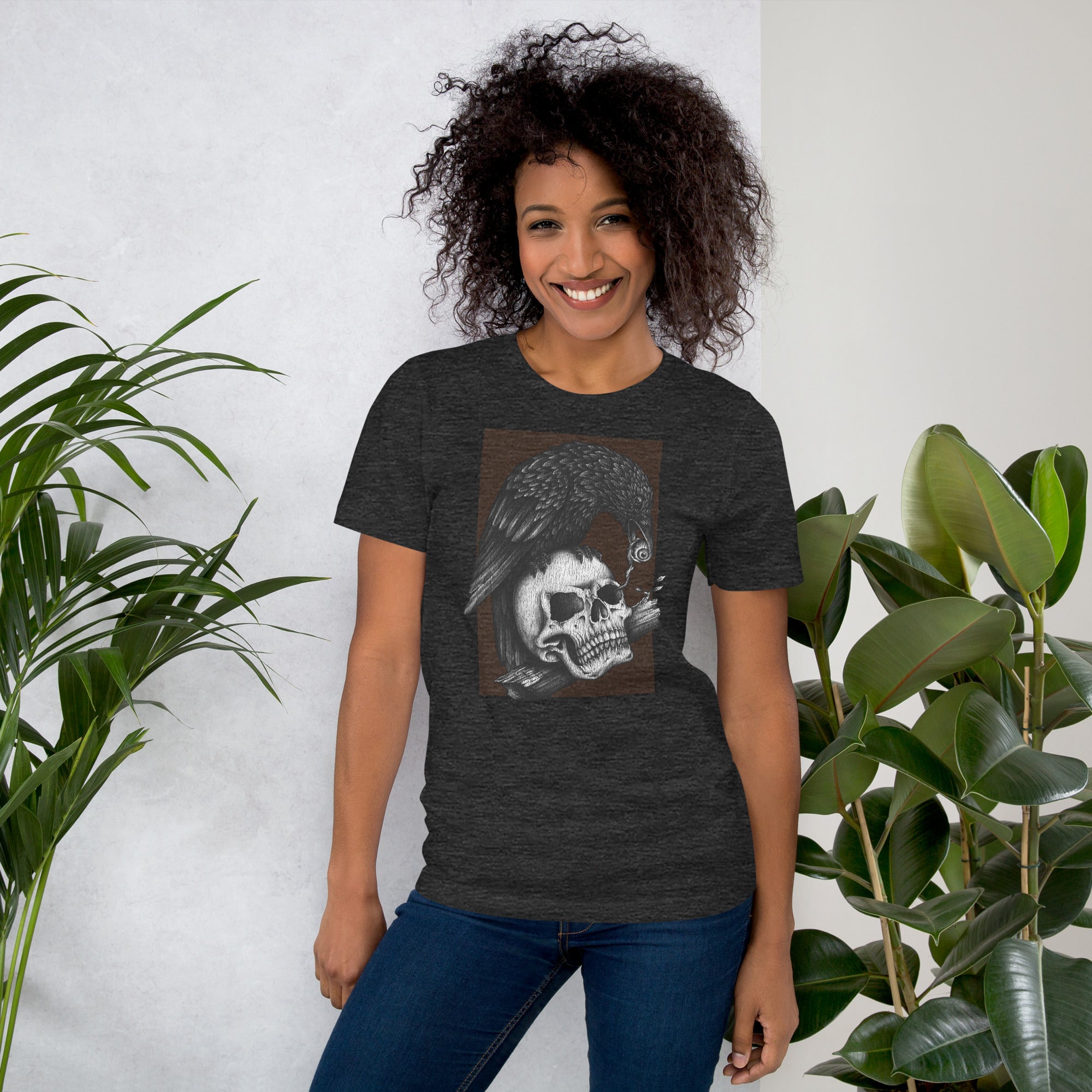 Graphite illustration of a black corvid perched on a human skull removing the eye, sprouting branch beside it, Last Look, Artificial Perdition apparel