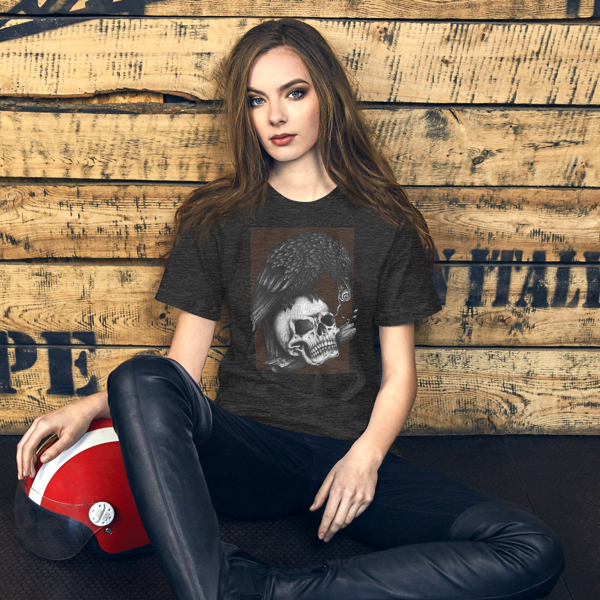 Graphite illustration of a black corvid perched on a human skull removing the eye, sprouting branch beside it, Last Look, Artificial Perdition apparel