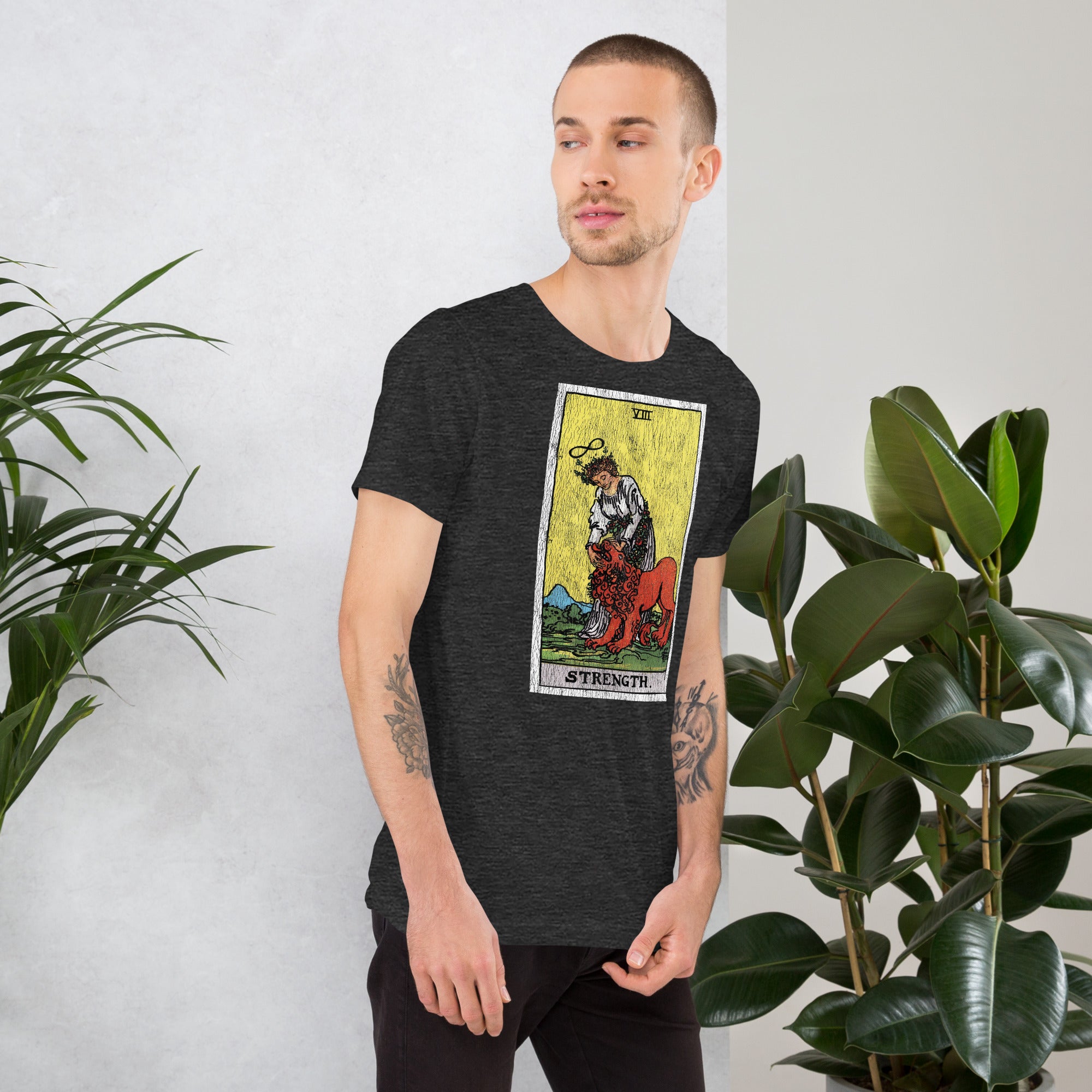 Card eight. The lion is already subdued, led by a chain of flowers. Strength is the quiet kind — fortitude, not force. Rider-Waite tarot apparel.