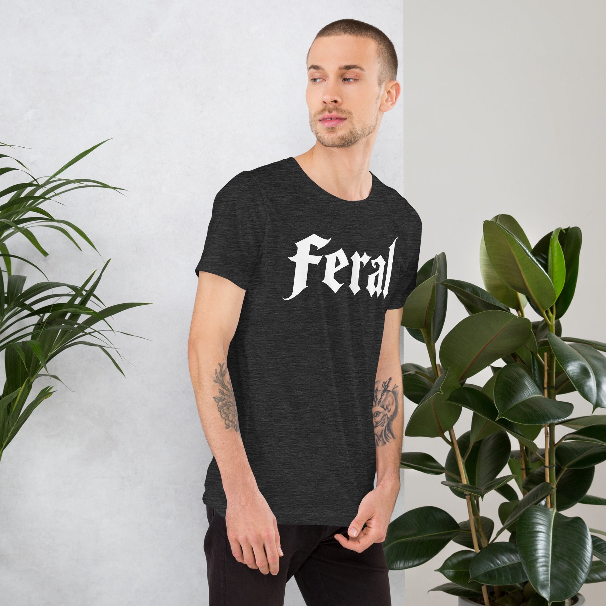 Feral in white blackletter font on dark heather grey t-shirt, bold single word graphic design, Artificial Perdition apparel