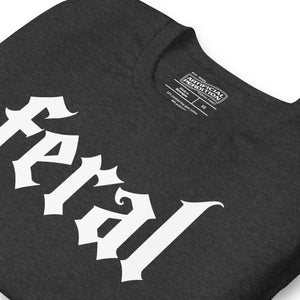 Feral in white blackletter font on dark heather grey t-shirt, bold single word graphic design, Artificial Perdition apparel