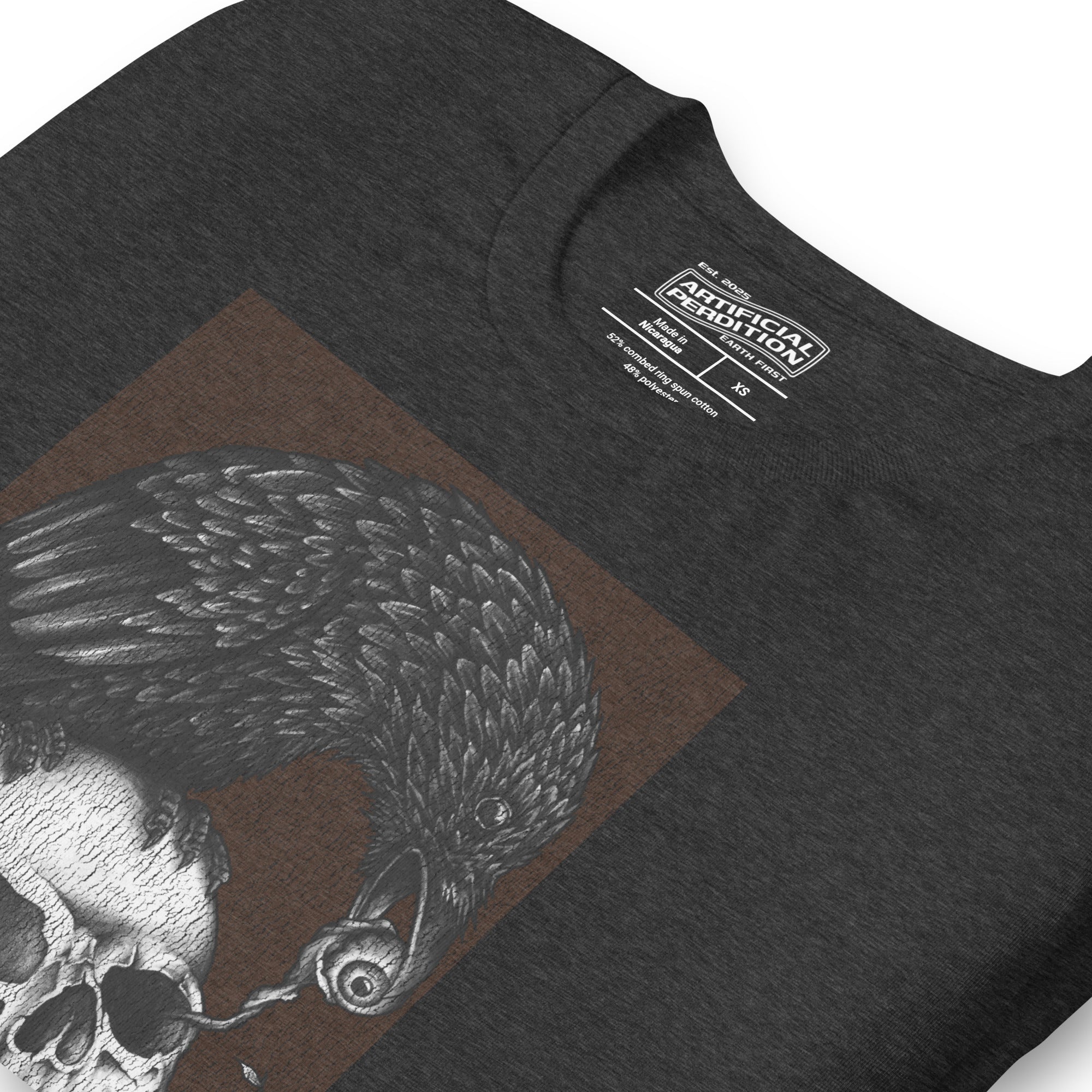 Graphite illustration of a black corvid perched on a human skull removing the eye, sprouting branch beside it, Last Look, Artificial Perdition apparel