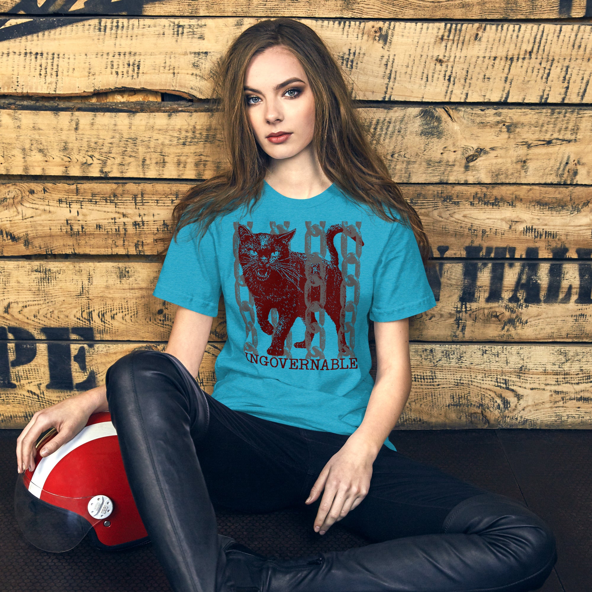 Snarling cat breaking through chains with UNGOVERNABLE text, dithered halftone red on cream, Artificial Perdition apparel