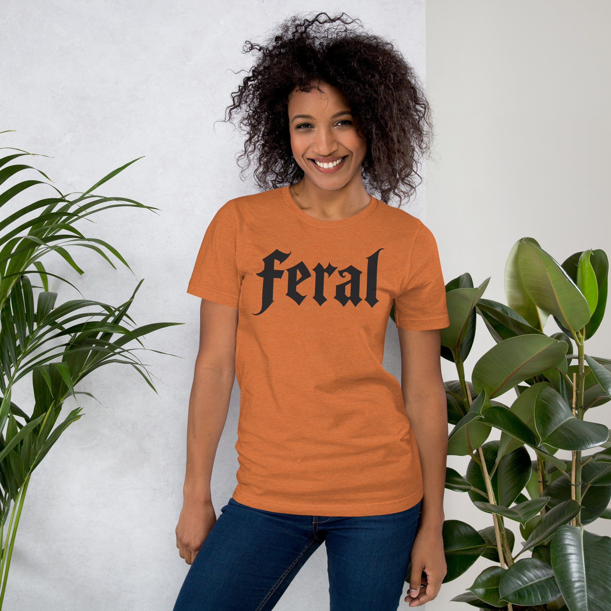Feral in white blackletter font on dark heather grey t-shirt, bold single word graphic design, Artificial Perdition apparel
