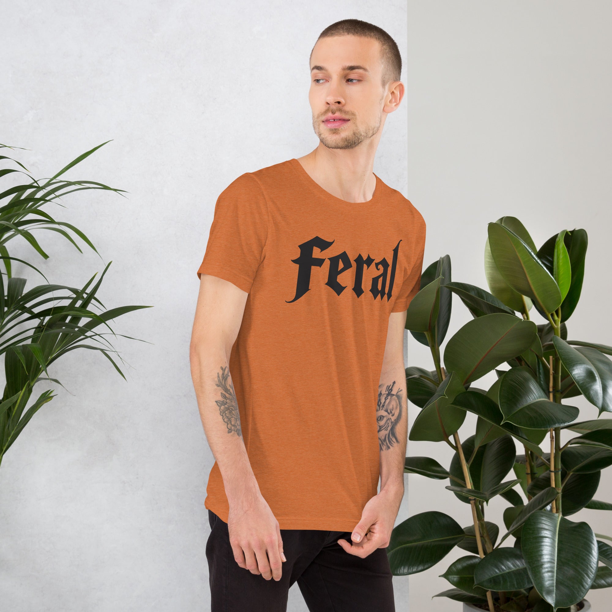 Feral in white blackletter font on dark heather grey t-shirt, bold single word graphic design, Artificial Perdition apparel