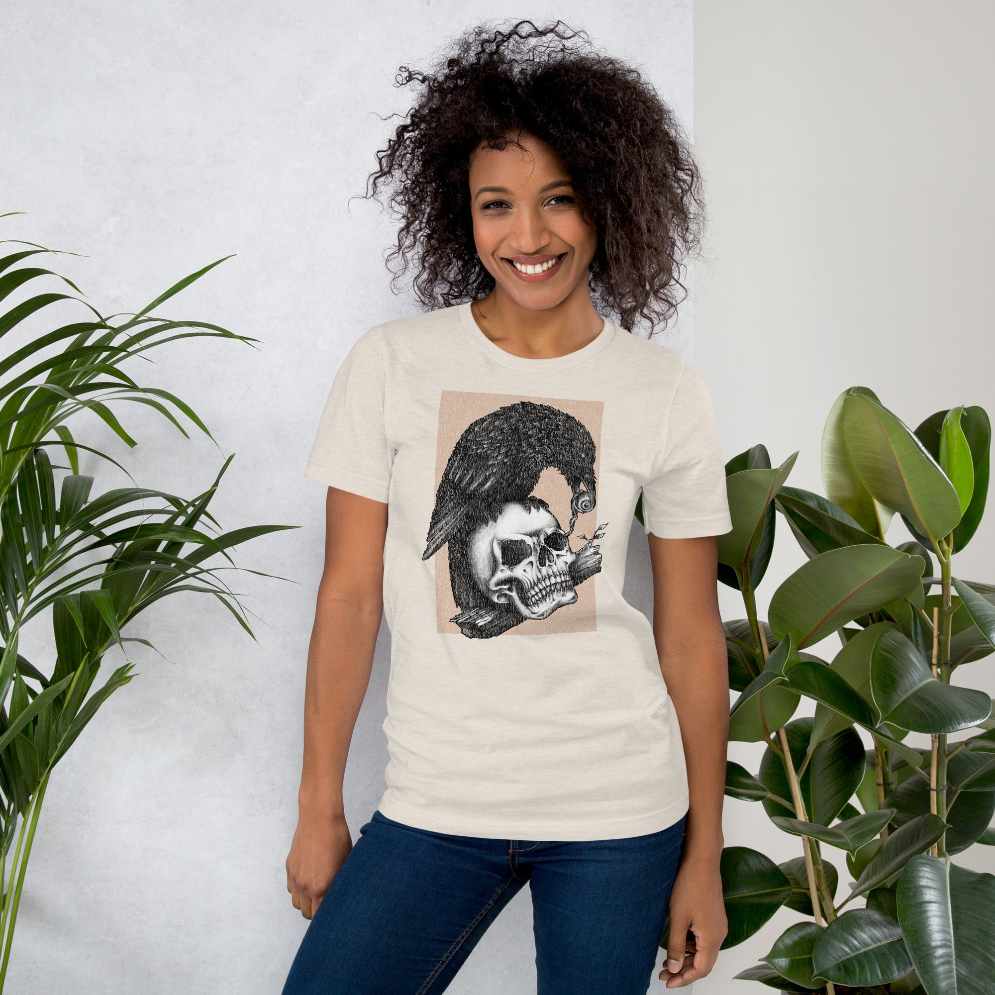 Graphite illustration of a black corvid perched on a human skull removing the eye, sprouting branch beside it, Last Look, Artificial Perdition apparel