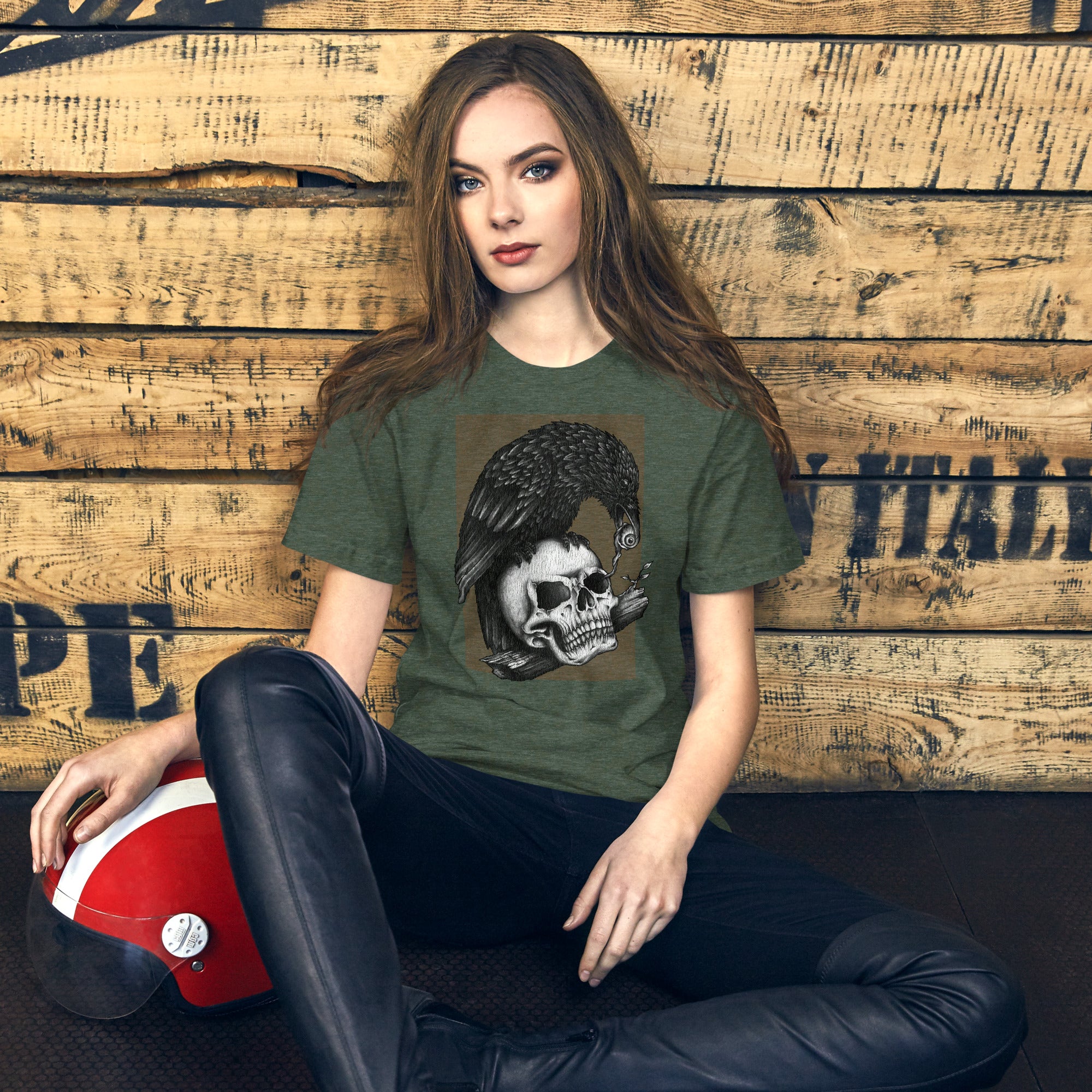 Graphite illustration of a black corvid perched on a human skull removing the eye, sprouting branch beside it, Last Look, Artificial Perdition apparel