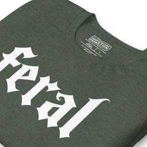 Feral in white blackletter font on dark heather grey t-shirt, bold single word graphic design, Artificial Perdition apparel
